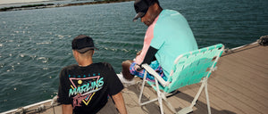 Rear shot of two models wearing Seaside Collection headwear and apparel